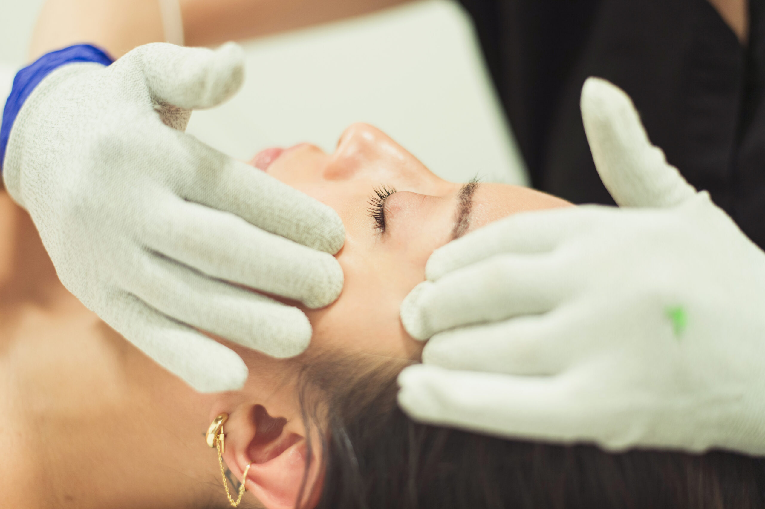 woman receiving facial with gua sha tool